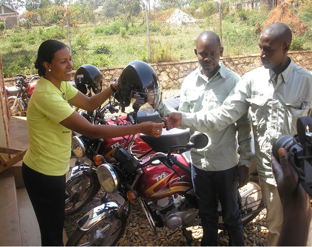 Lilly handing over to Bosco and Livas of Kiziranfumbi Sub County
